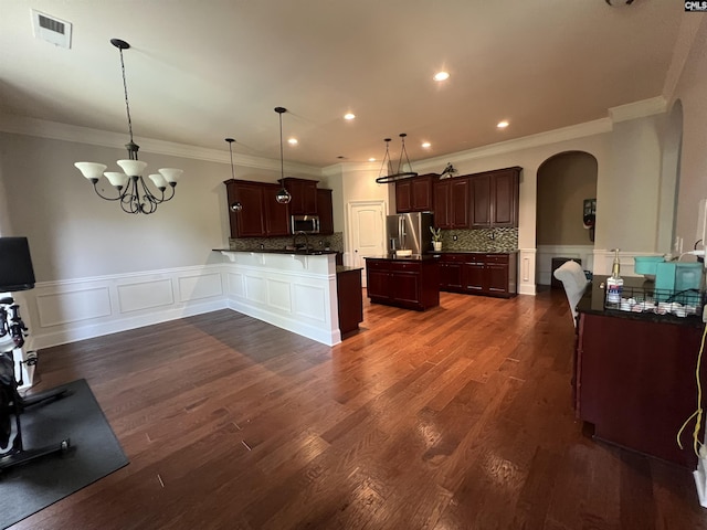 127 Brooklet Dr, Lexington, SC 29072 - kitchen with appliances with stainless steel finishes, arched walkways, ornamental molding, a wainscoted wall, and a decorative wall
