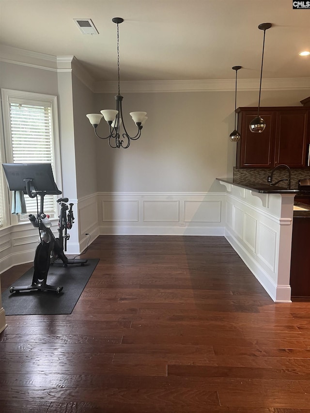 127 Brooklet Dr, Lexington, SC 29072 - unfurnished dining area with ornamental molding, a chandelier, wainscoting, a decorative wall, and dark wood-style floors