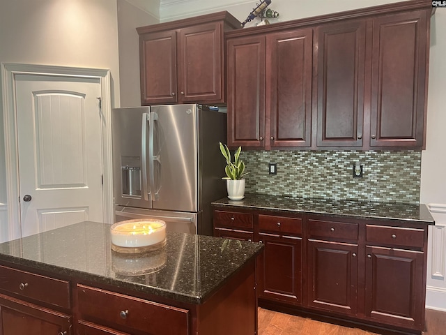 127 Brooklet Dr, Lexington, SC 29072 - kitchen featuring stainless steel fridge with ice dispenser, dark stone countertops, tasteful backsplash, light wood-style flooring, and a kitchen island