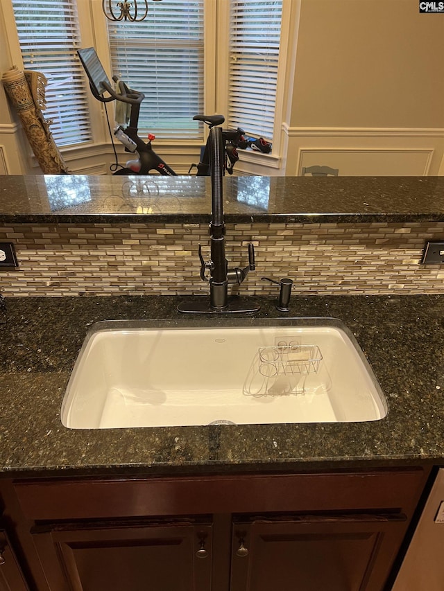 127 Brooklet Dr, Lexington, SC 29072 - kitchen view of backsplash, dark stone countertops, and dark brown cabinetry