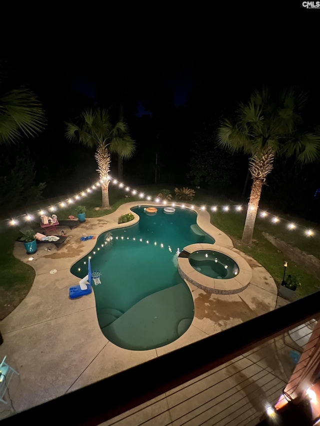 127 Brooklet Dr, Lexington, SC 29072 - pool at night featuring a pool with connected hot tub and a patio area