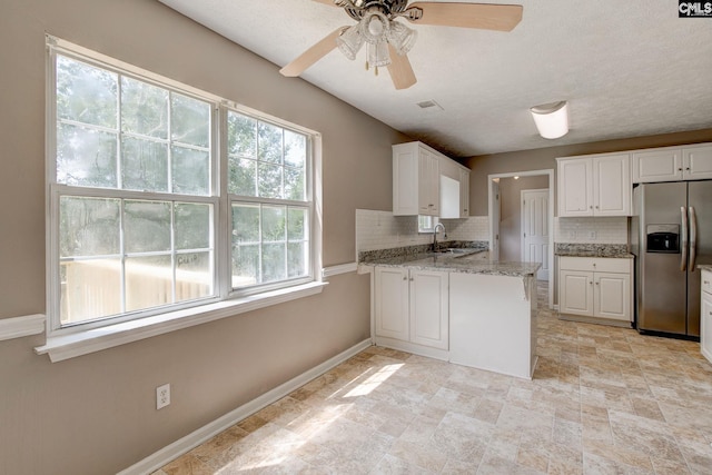 211 Glendevon Way, Columbia, SC 29229 - kitchen with stainless steel refrigerator with ice dispenser, backsplash, and white cabinetry