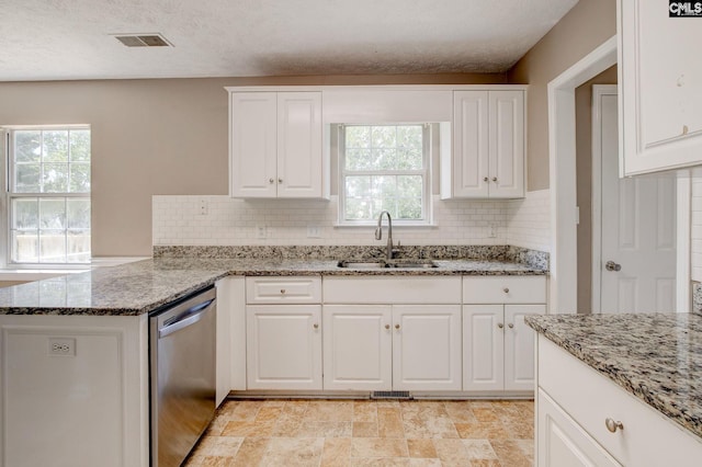 211 Glendevon Way, Columbia, SC 29229 - kitchen featuring stainless steel dishwasher, healthy amount of natural light, tasteful backsplash, white cabinetry, and a textured ceiling