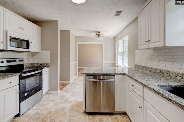 211 Glendevon Way, Columbia, SC 29229 - kitchen featuring stainless steel appliances, a peninsula, white cabinetry, ceiling fan, and a textured ceiling