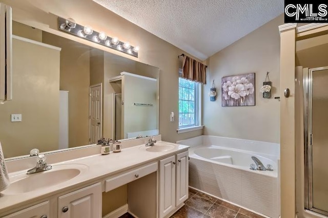 211 Lothrop Hill Rd, Lexington, SC 29072 - bathroom featuring a stall shower, vaulted ceiling, a garden tub, double vanity, and a textured ceiling
