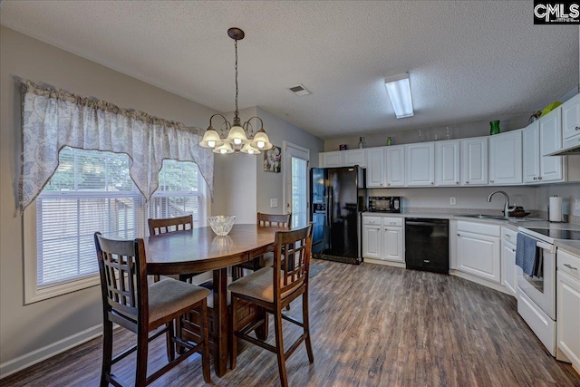 27 Lacebark Ln, Elgin, SC 29045 - dining area with plenty of natural light, dark wood-style floors, a chandelier, and a textured ceiling
