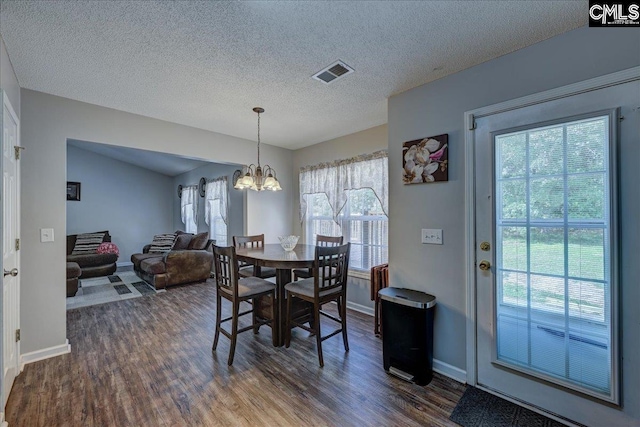 27 Lacebark Ln, Elgin, SC 29045 - dining space featuring dark wood finished floors, a chandelier, and a textured ceiling