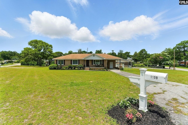 1159 Starview Dr, West Columbia, SC 29172 - ranch-style house with a front lawn, driveway, covered porch, and an attached garage