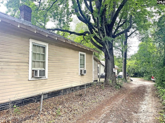 706 Violet St, West Columbia, SC 29169 - view of side of home featuring a chimney, cooling unit, and crawl space
