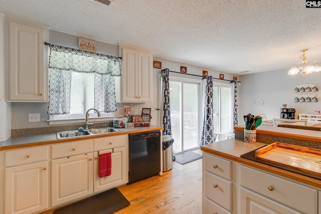 1037 Ridgeview Cir, Elgin, SC 29045 - kitchen featuring black dishwasher, a textured ceiling, light wood finished floors, a chandelier, and decorative light fixtures