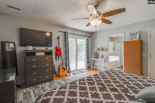 1037 Ridgeview Cir, Elgin, SC 29045 - bedroom with access to exterior, wood finished floors, a textured ceiling, ensuite bathroom, and ceiling fan