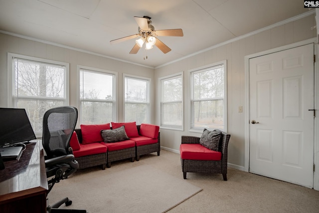 carpeted office featuring crown molding and ceiling fan