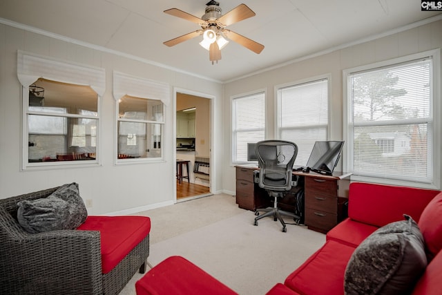 carpeted home office featuring crown molding, ceiling fan, and a healthy amount of sunlight