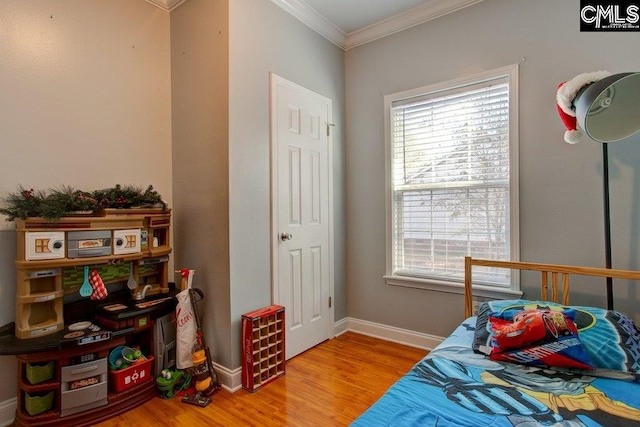 bedroom featuring crown molding and light wood-type flooring