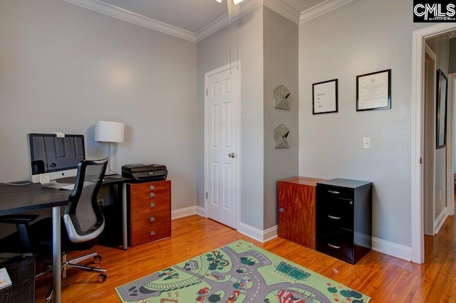 office area with ornamental molding and light hardwood / wood-style floors