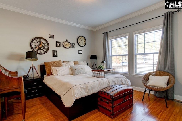 bedroom featuring ornamental molding and wood-type flooring