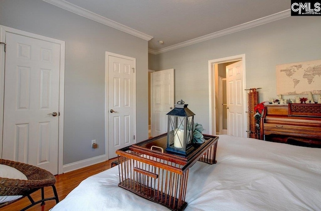 bedroom with hardwood / wood-style flooring and crown molding