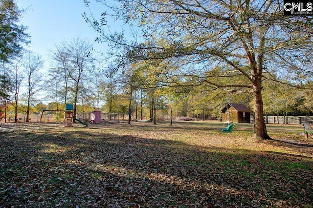 view of yard with an outdoor structure and a playground