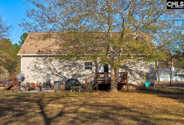 rear view of house with a yard, a deck, and a patio