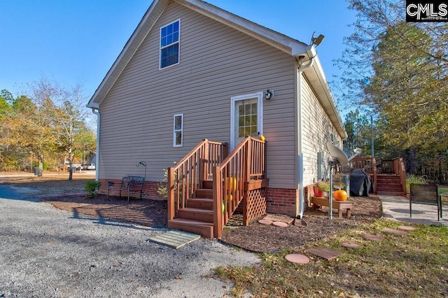 rear view of house featuring a deck