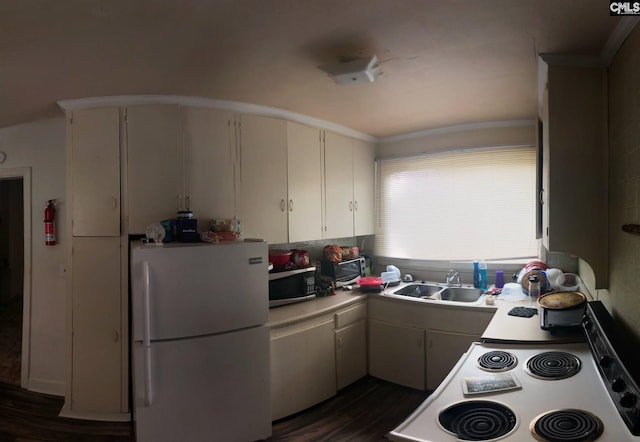 kitchen featuring white fridge, white cabinetry, dark hardwood / wood-style flooring, range, and sink