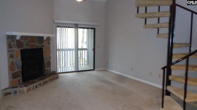 unfurnished living room featuring a fireplace and light colored carpet