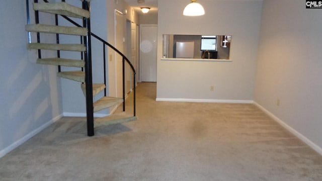 basement with light colored carpet and fridge