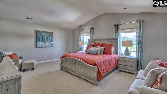 carpeted bedroom with vaulted ceiling and multiple windows