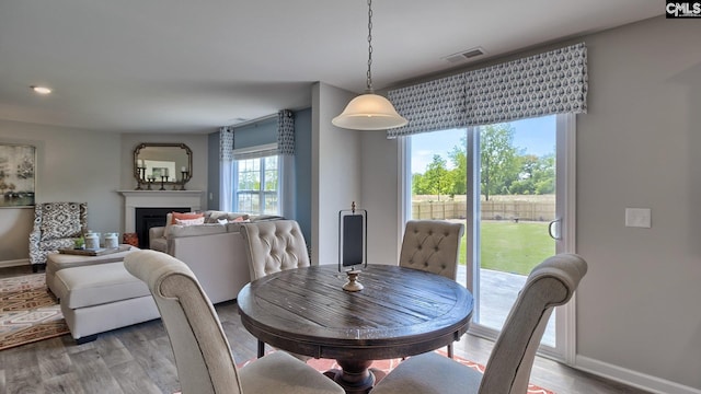 dining space with a healthy amount of sunlight and light hardwood / wood-style floors