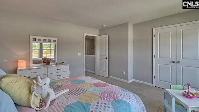 bedroom featuring light colored carpet and a closet