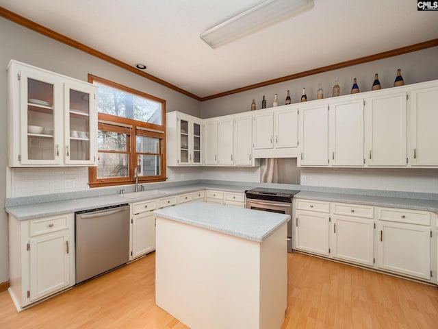 kitchen with white cabinets, light hardwood / wood-style flooring, and stainless steel appliances