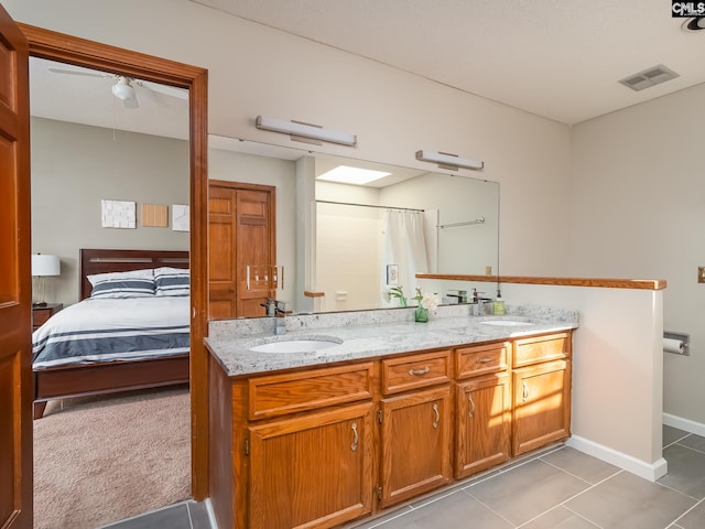 bathroom featuring tile floors and double vanity