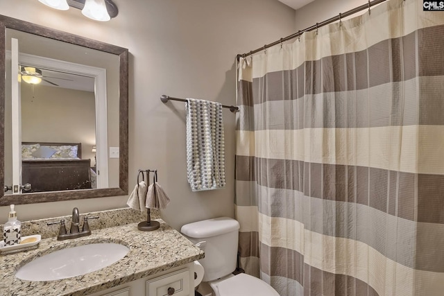 bathroom featuring ceiling fan, toilet, and vanity