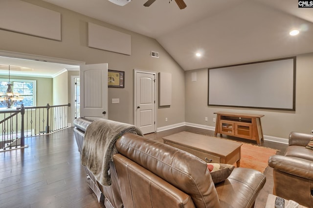 home theater room with dark hardwood / wood-style floors, ceiling fan with notable chandelier, and vaulted ceiling