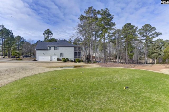 view of front of property with a front yard and a garage