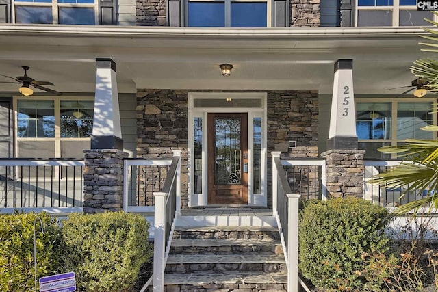 property entrance with ceiling fan and a porch