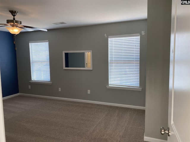 carpeted spare room featuring ceiling fan