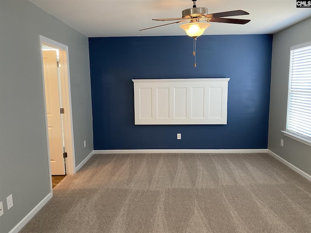 carpeted empty room with ceiling fan