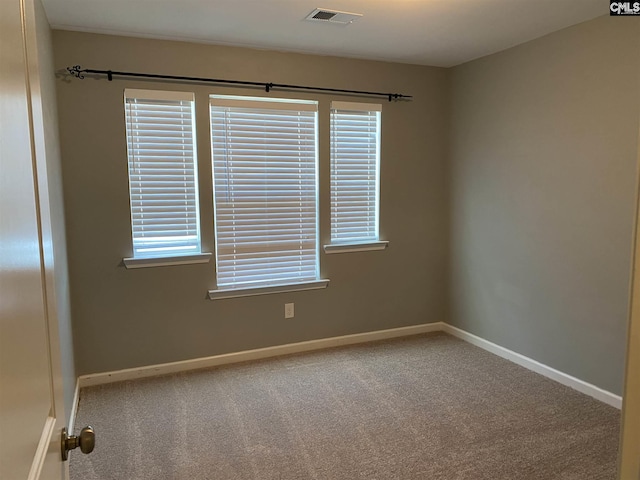 carpeted spare room with a healthy amount of sunlight