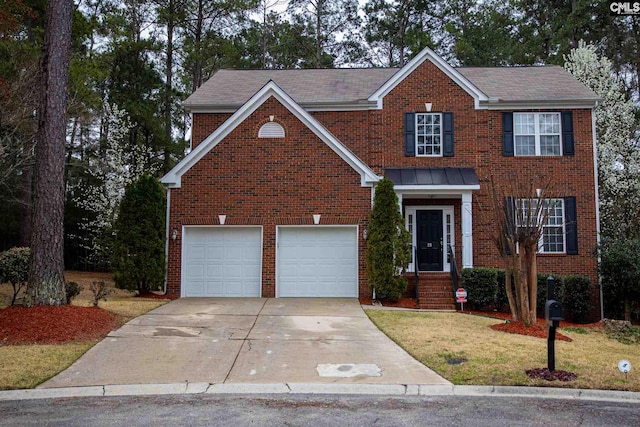 view of front of home featuring a front lawn and a garage