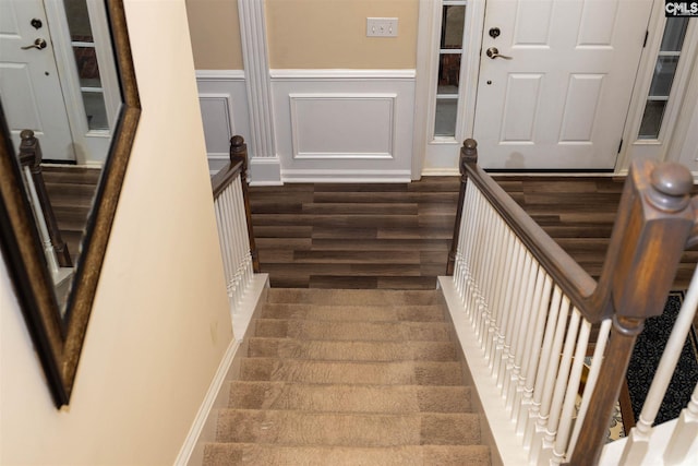 staircase featuring dark hardwood / wood-style floors