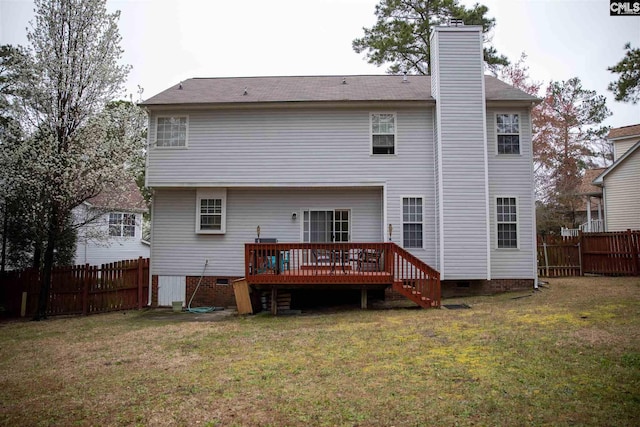 back of house featuring a wooden deck and a yard