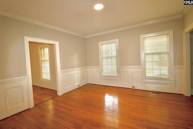 spare room featuring light hardwood / wood-style flooring and ornamental molding