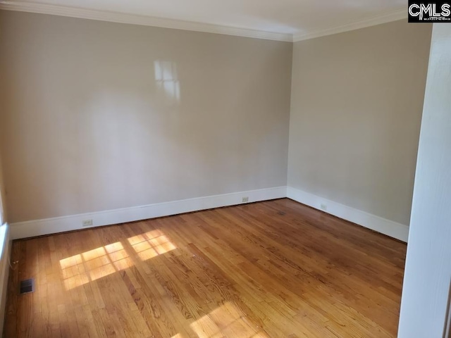 unfurnished room with light hardwood / wood-style floors and ornamental molding