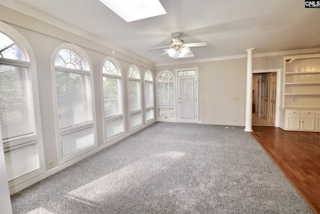 unfurnished sunroom featuring a skylight and ceiling fan