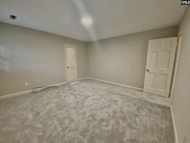 unfurnished room featuring light colored carpet