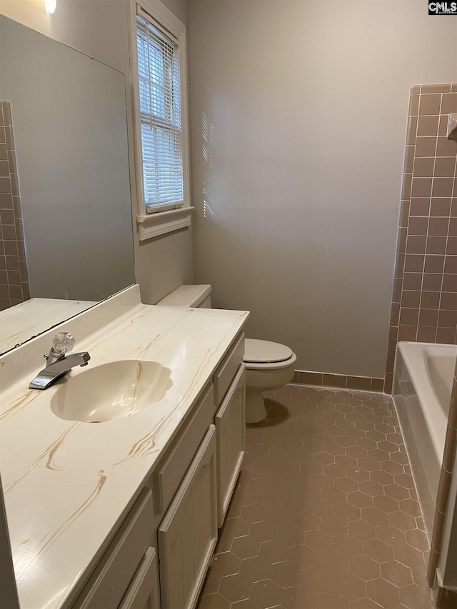 bathroom with toilet, tile floors, and vanity