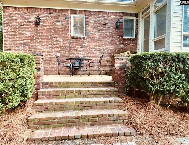 entrance to property featuring a patio area