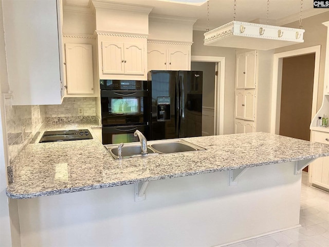 kitchen featuring light tile floors, tasteful backsplash, black appliances, hanging light fixtures, and sink