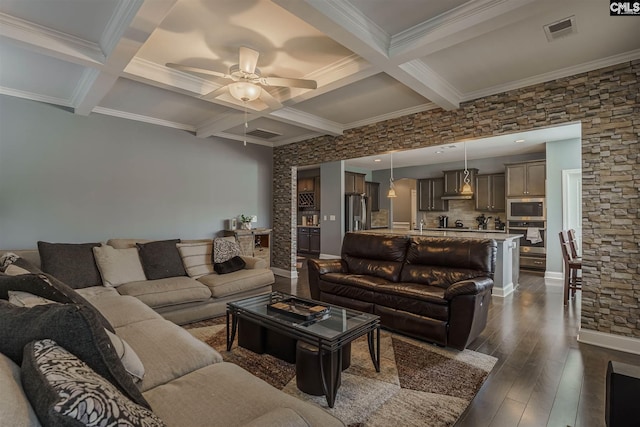 living room featuring coffered ceiling, dark wood-type flooring, ceiling fan, and beam ceiling